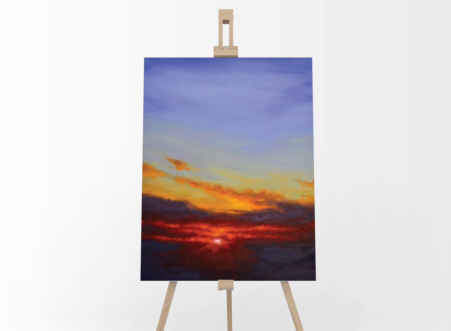 Blazing Skies Oil Painting Sky Landscape by Andrew Gaia on easel. Painting of the warm sunrise cutting through the clouds to reveal the cool blue sky.